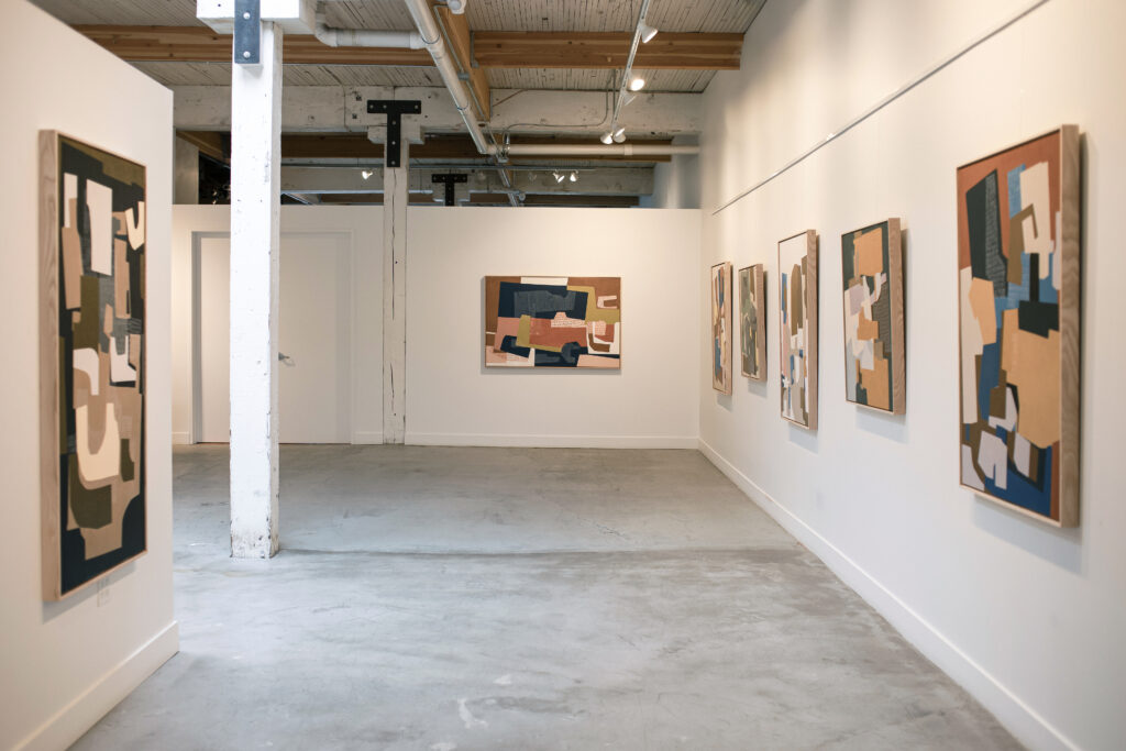 Rubeena Ratcliffe paintings hung on the walls at Seattle Art Source.