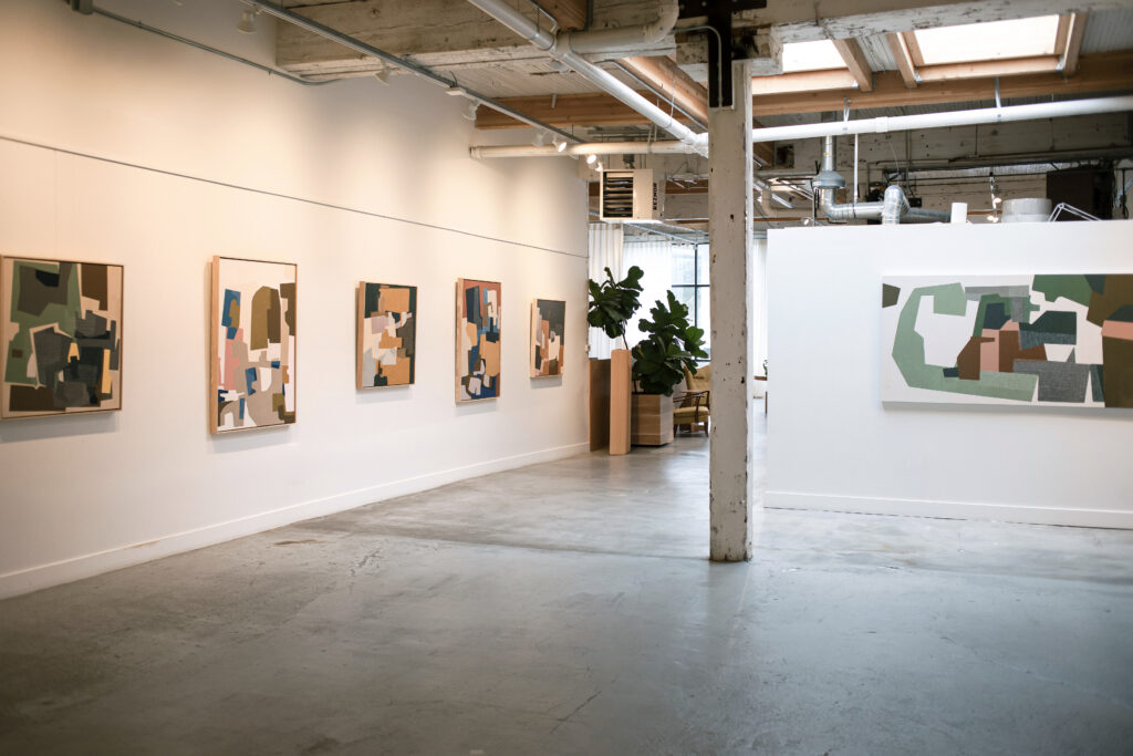 Rubeena Ratcliffe paintings hung on the wall at Seattle Art Source